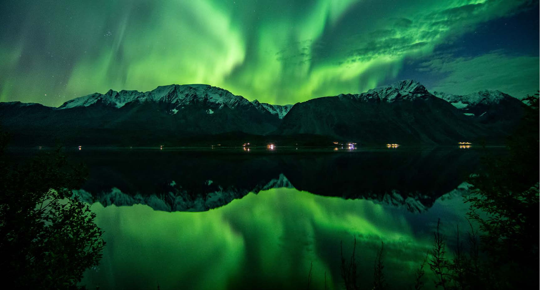 Northern lights reflected in the fjord