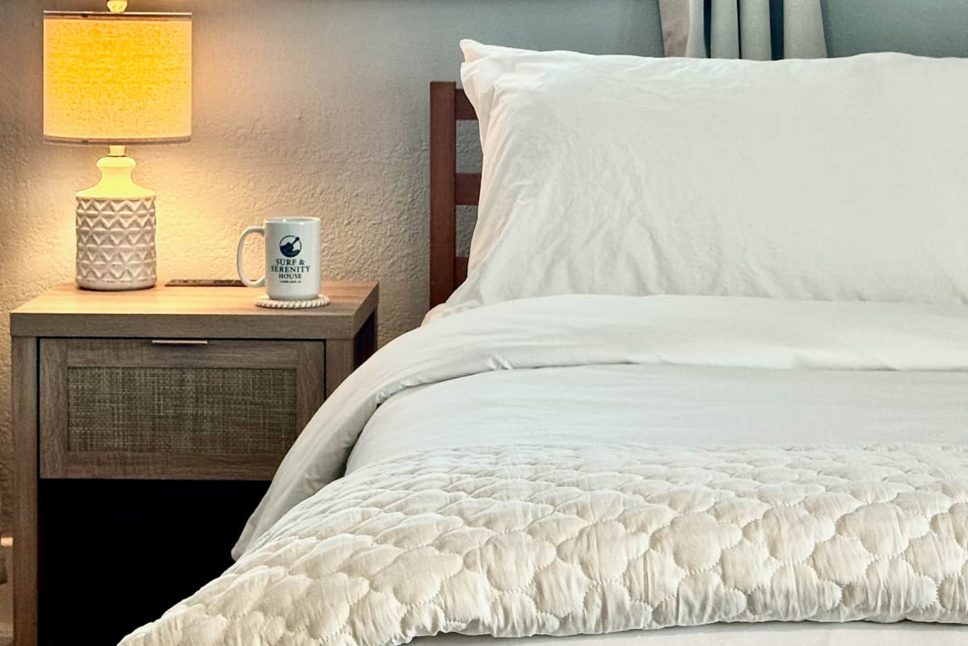 King bedroom premium linens and bedside details at Surf & Serenity House