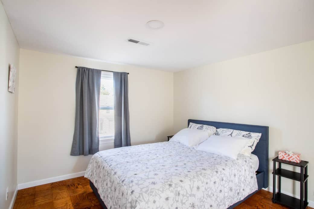 Serene Bedroom Retreat: Relax in a light-filled space with stylish decor and plush bedding!