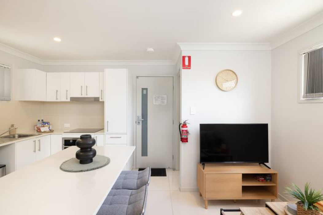 Living Area: Bright living space with comfortable seating and TV 