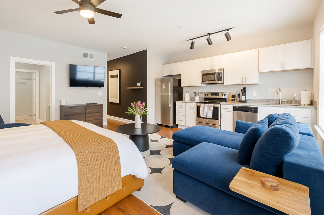 Open-concept living room with full kitchen and bright natural light.