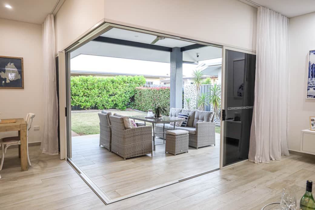 Living room opens to the veranda with sliding doors—bringing in light, breeze, and indoor-outdoor fl