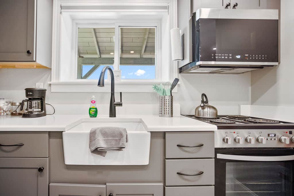 Efficiency kitchen, coffee pot with basket filter, shared BBQ outdoors. 