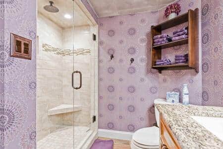 Attached main bathroom with waterfall shower. Attached main bathroom with waterfall shower.