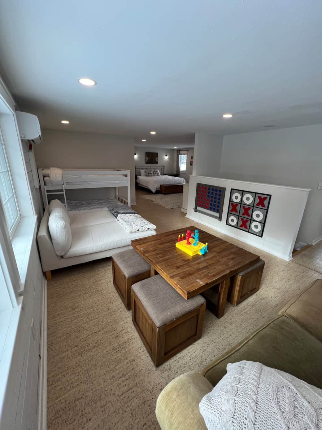 Game room in the loft with large windows, plenty of seating