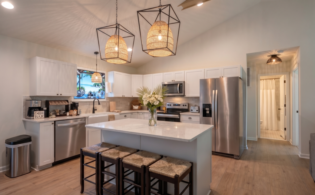 Fully equipped kitchen featuring a central island, cookware, baking supplies, and Keurig.