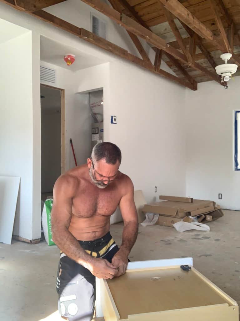Owner of Casa Citron personally building custom kitchen cabinetry during renovation, showcasing hands-on architectural design and craftsmanship near Wilton Manors, Florida.