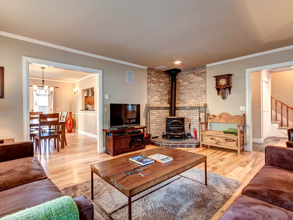 Wood burning fireplace in the open plan living room on the main level