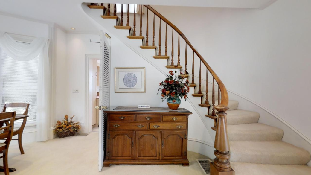 The antique spiral staircase leads from the foyer and dining room to the upstairs bedrooms and bath