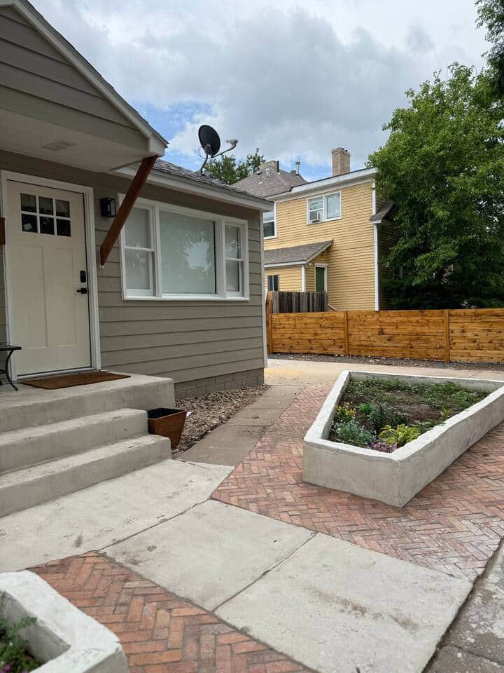 Follow the charming brick path past the flower bed and into your home away from home! Fresh blooms, a cozy porch, and a peaceful vibe greet you the moment you arrive.