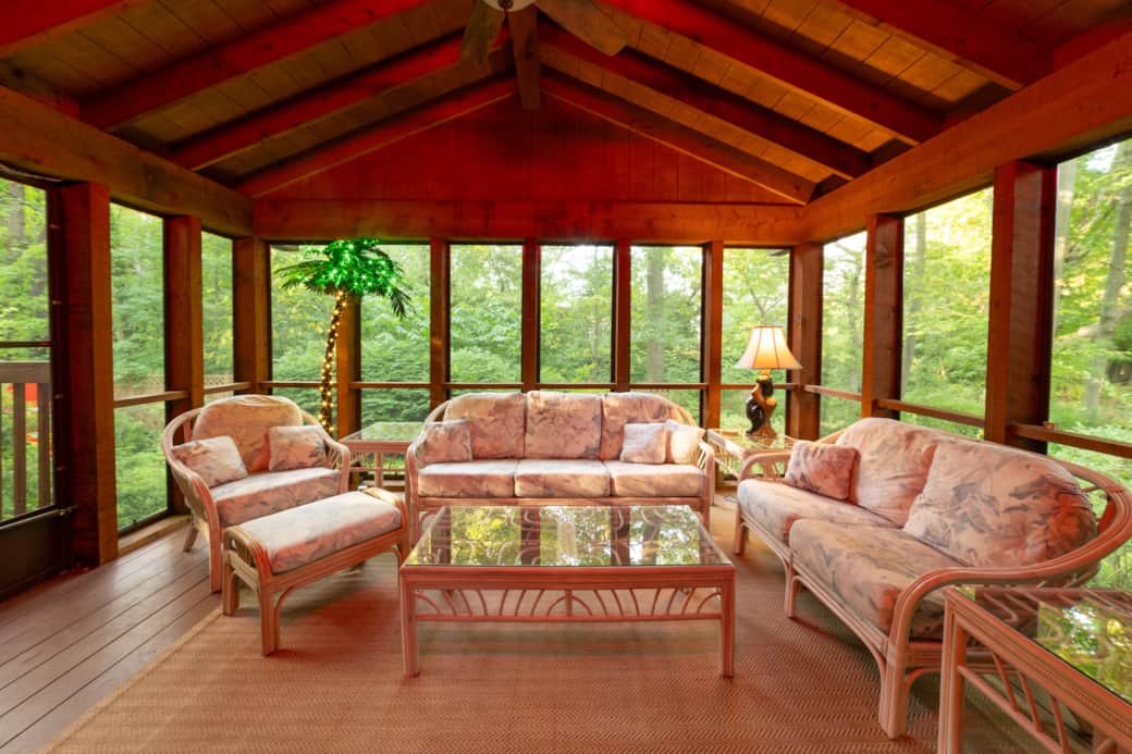 Private screened-in porch with palm tree lights and cozy lounge seating Private screened-in porch with palm tree lights and cozy lounge seating