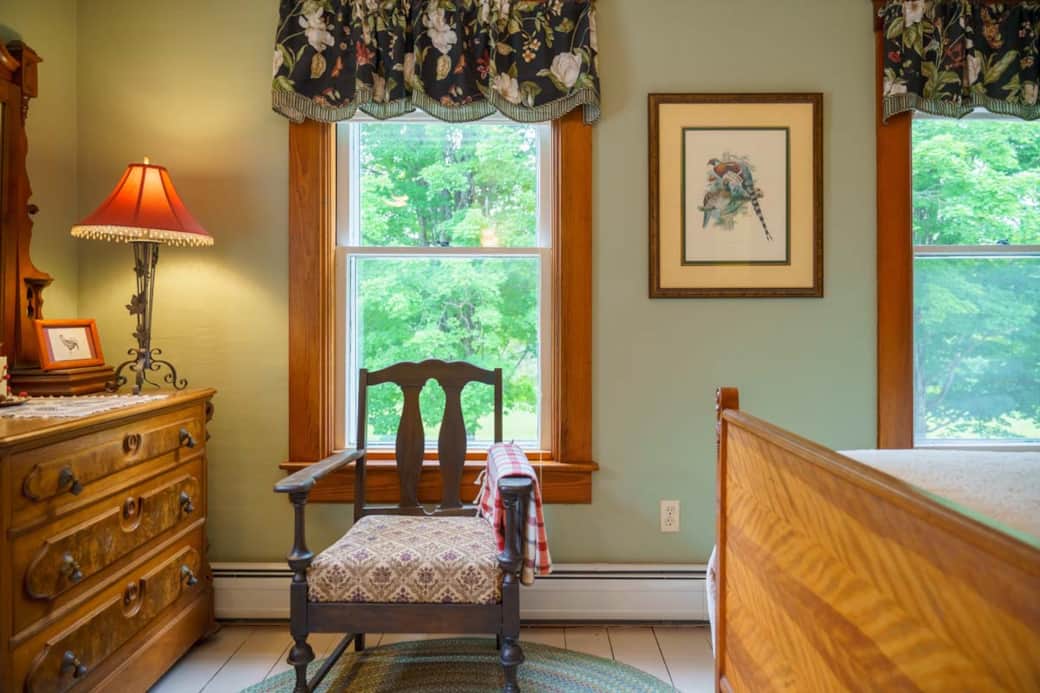 Antique chair and armoire highlight the room’s classic farmhouse style. Antique chair and armoire highlight the room’s classic farmhouse style.