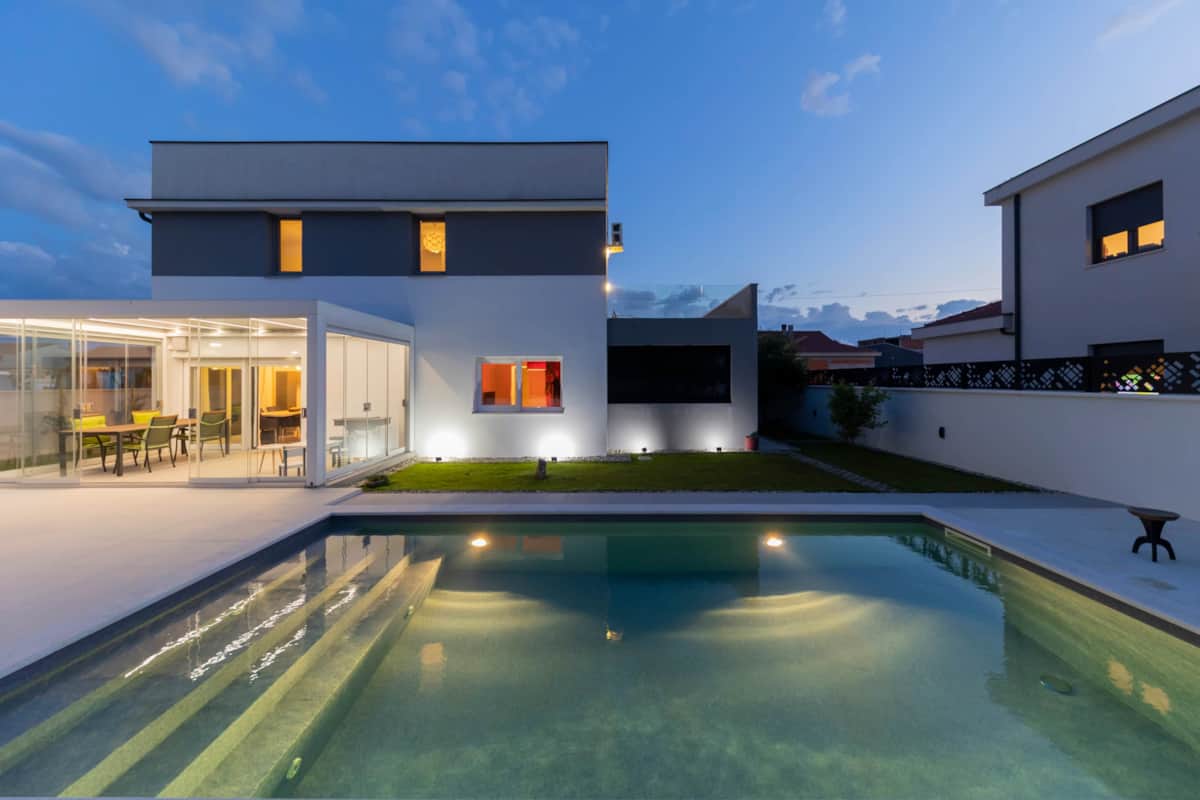 Alba Family Home and pool lit up in the evening