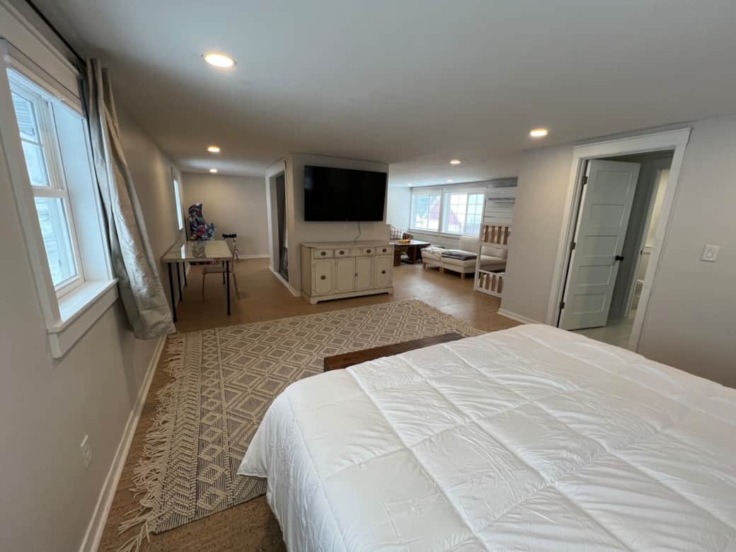 King bed in loft with blackout and light filtering curtains and 65" smart tv with disney+/hulu bundl