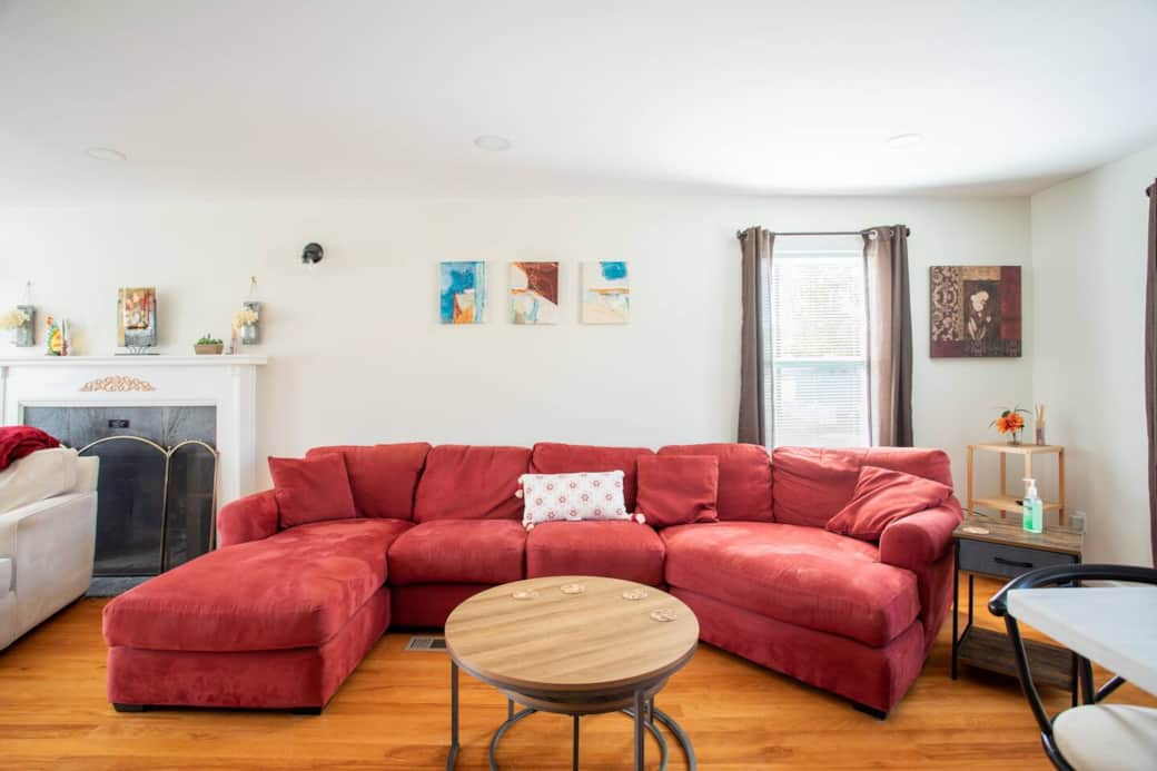 Living Room: Vibrant reds and bright art create a lively space for relaxation and fun gatherings!