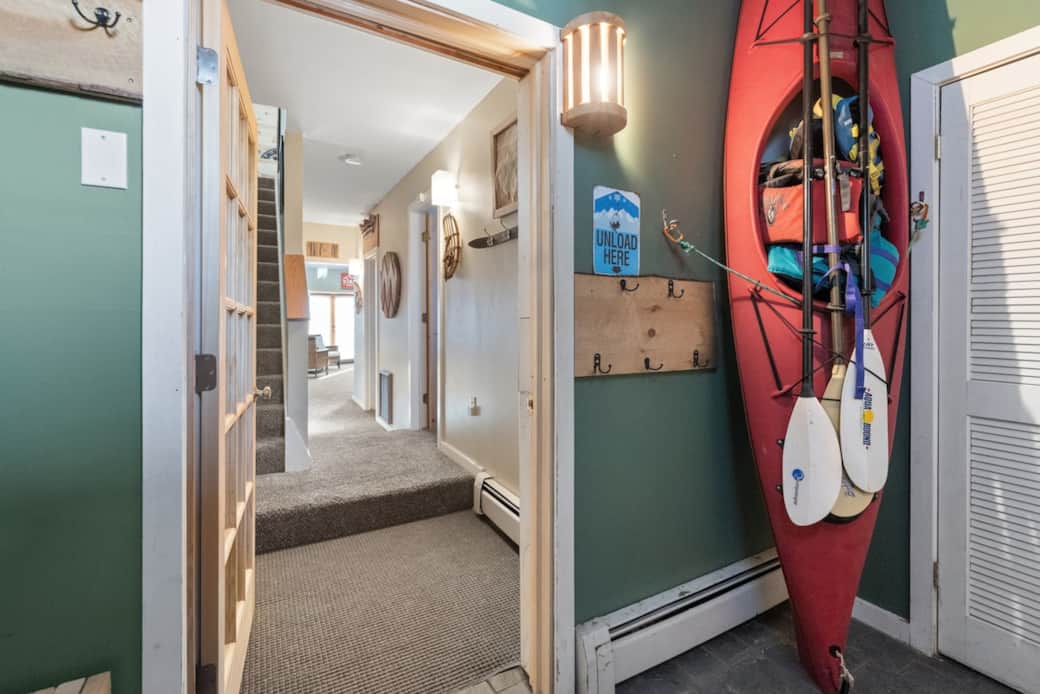 1st Mudroom from main entrance.  2nd mudroom visible through door.  A 3rd mudroom area is off the back deck.  Plenty of room to unload and store gear out of the way.  Hooks over heater helps dry out clothing.