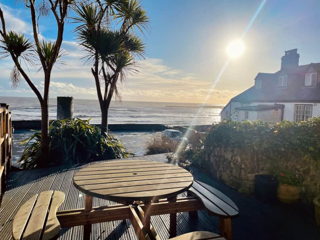 The stunning bay view from the outdoor terrace. Picnic bench to sit and gaze at the surroundings, take a hot drink out there first thing in the morning, priceless!