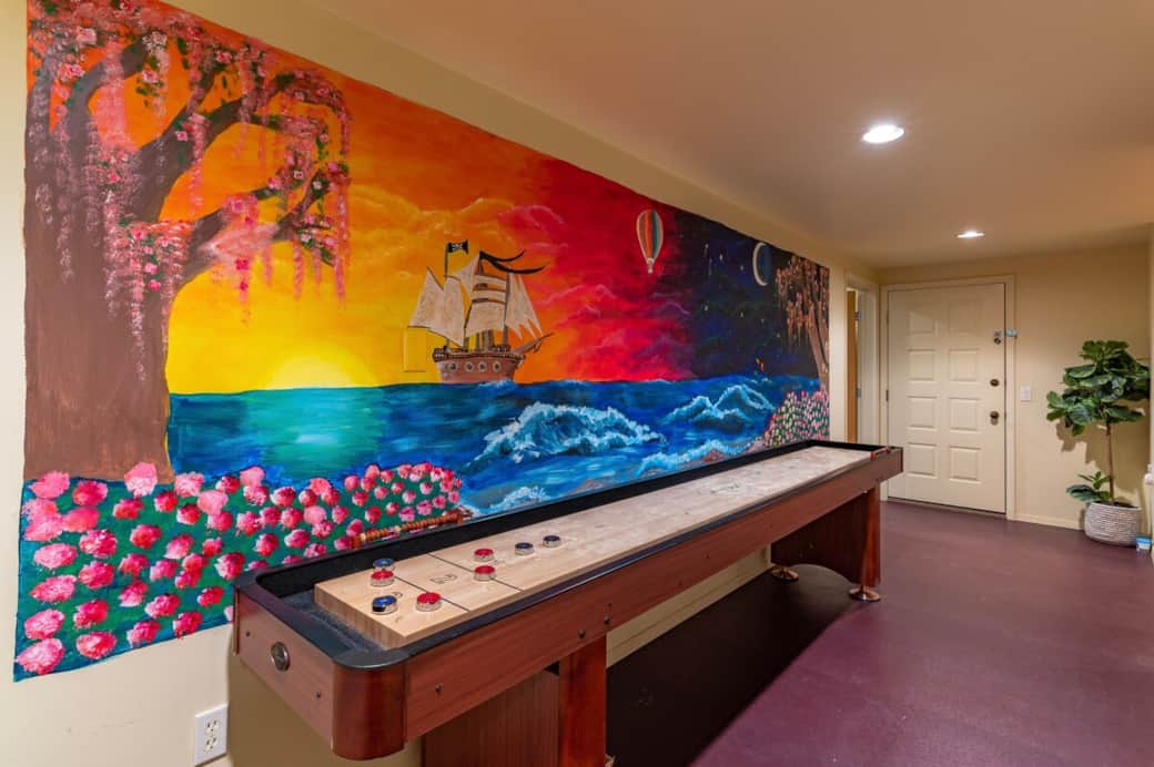 12 foot shuffleboard table (and whimsical mural!) in the downstairs entertainment area. 12 foot shuffleboard table (and whimsical mural!) in the downstairs entertainment area.