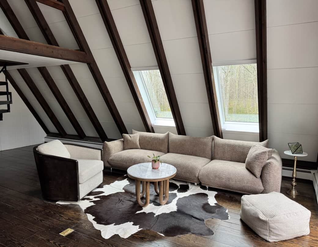 Main-floor living room with vaulted ceilings, a ceiling fan, fireplace and remote-controlled AC and heat climate comfort. 