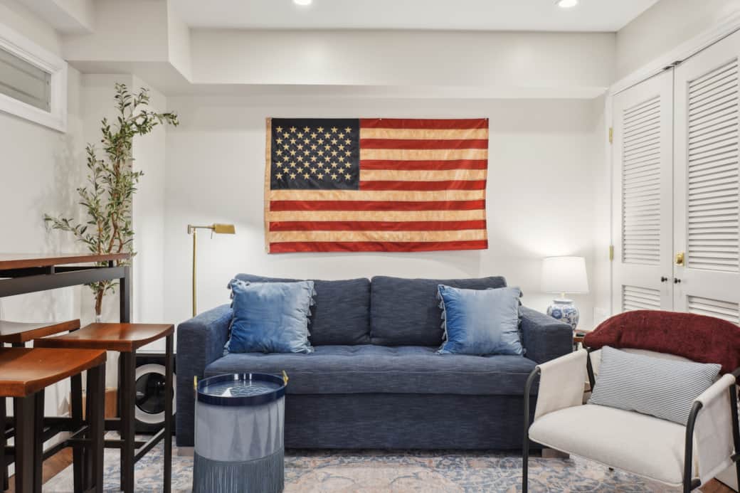 Stylish living room with queen sofa bed, cozy lighting, and decor