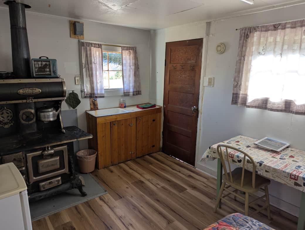 Cabin 9 is a cozy rustic cabin that features a wood-burning stove.