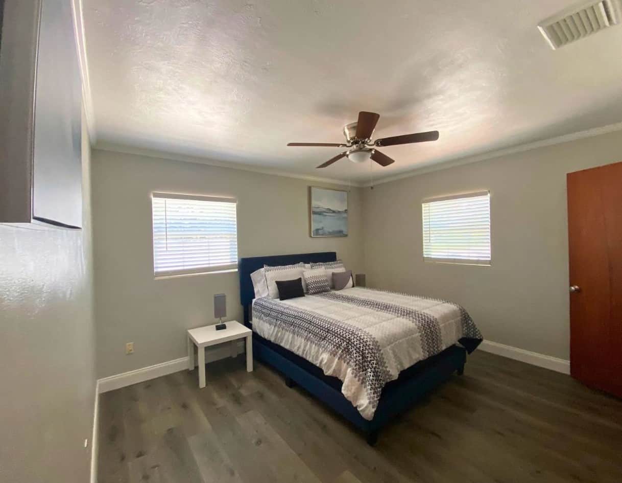 Bright, spacious queen bedroom with ceiling fan and beautiful decorative wall art. Lakeland, FL