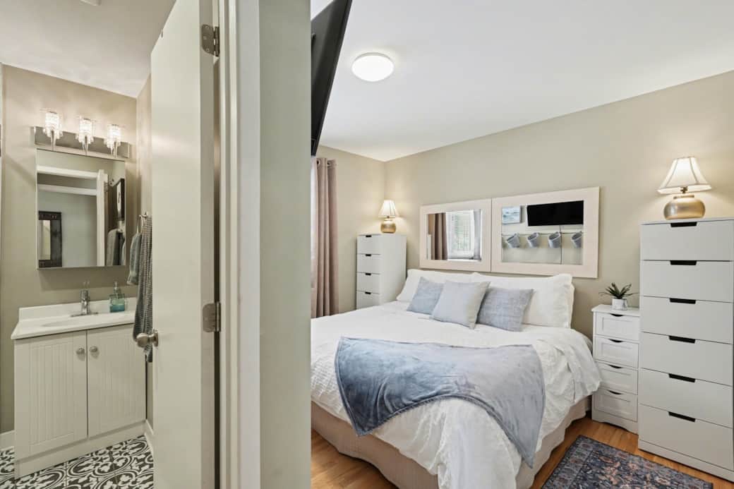Serene bedroom #1 with large window and ensuite bathroom in Ottawa.