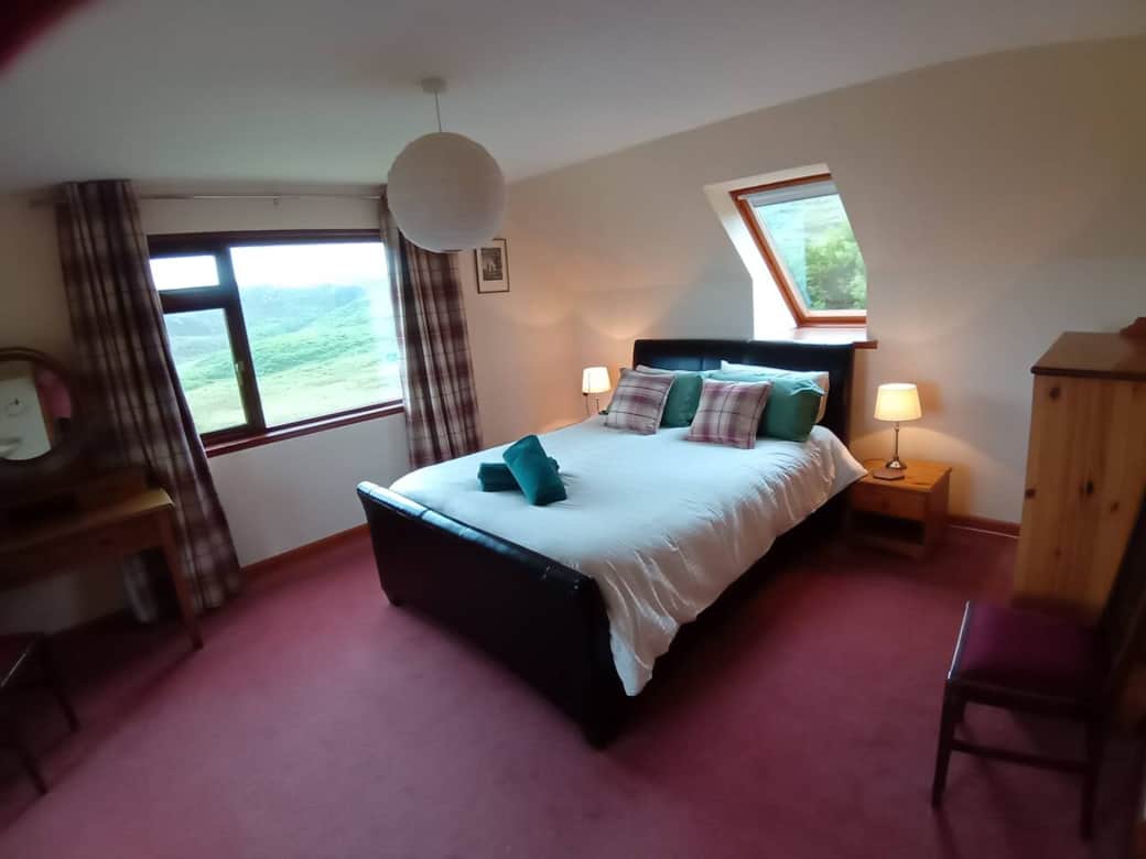 Master Bedroom with views to waterfall at the back and sea views to the front.  Bedroom has a basin and walk in wardrobe.  