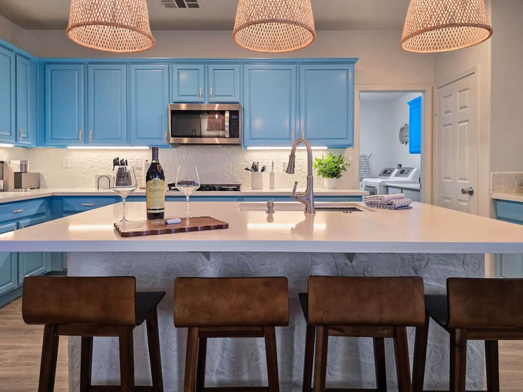 Quartz kitchen island with seating and bright lighting. Quartz kitchen island with seating and bright lighting.