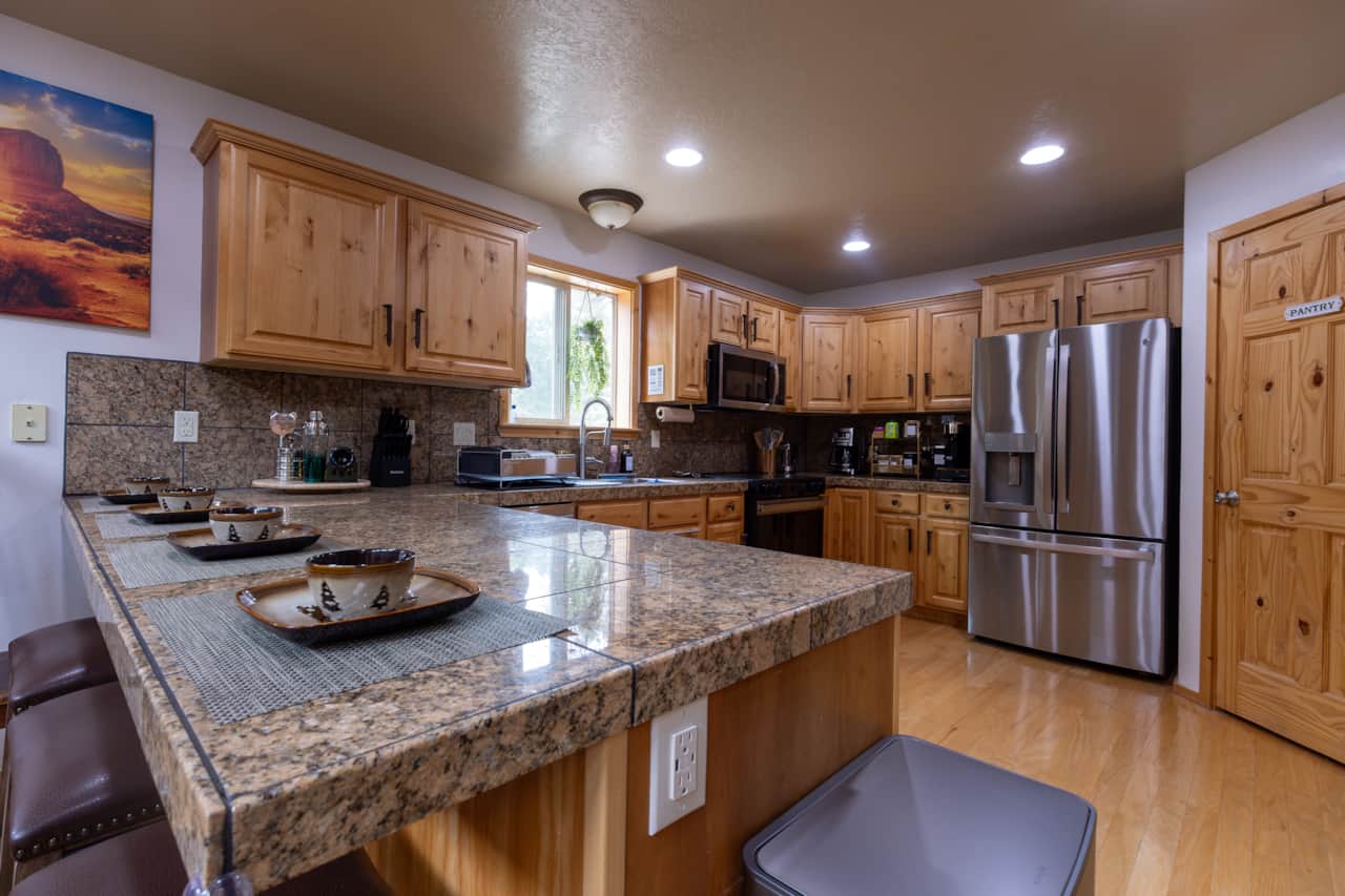 Fully Equipped Kitchen • Granite Island & Bar Seating