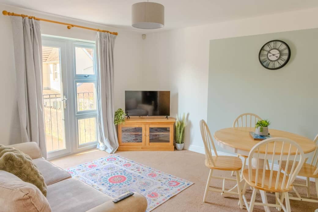 Living room with large windows & dining space