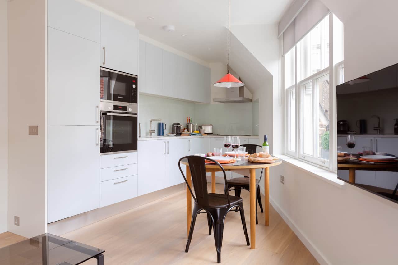 Sleek kitchen with integrated Bosch oven and pendant lighting