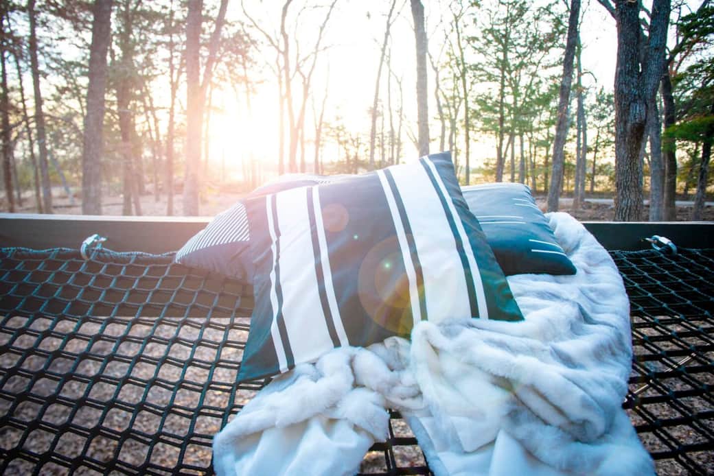 A treehouse wouldn't be complete without a hammock. Lounge 8' above the forest floor surrounded by pillows and blankets on a massive 6' x 12' netted hammock deck, accessible from the entry deck. A treehouse wouldn't be complete without a hammock. Lounge 8' above the forest floor surrounded by pillows and blankets on a massive 6' x 12' netted hammock deck, accessible from the entry deck.