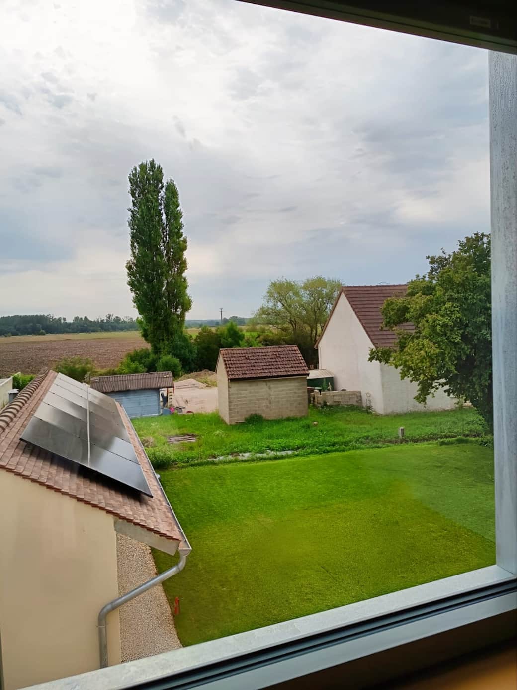 View of the garden, sauna and fields.