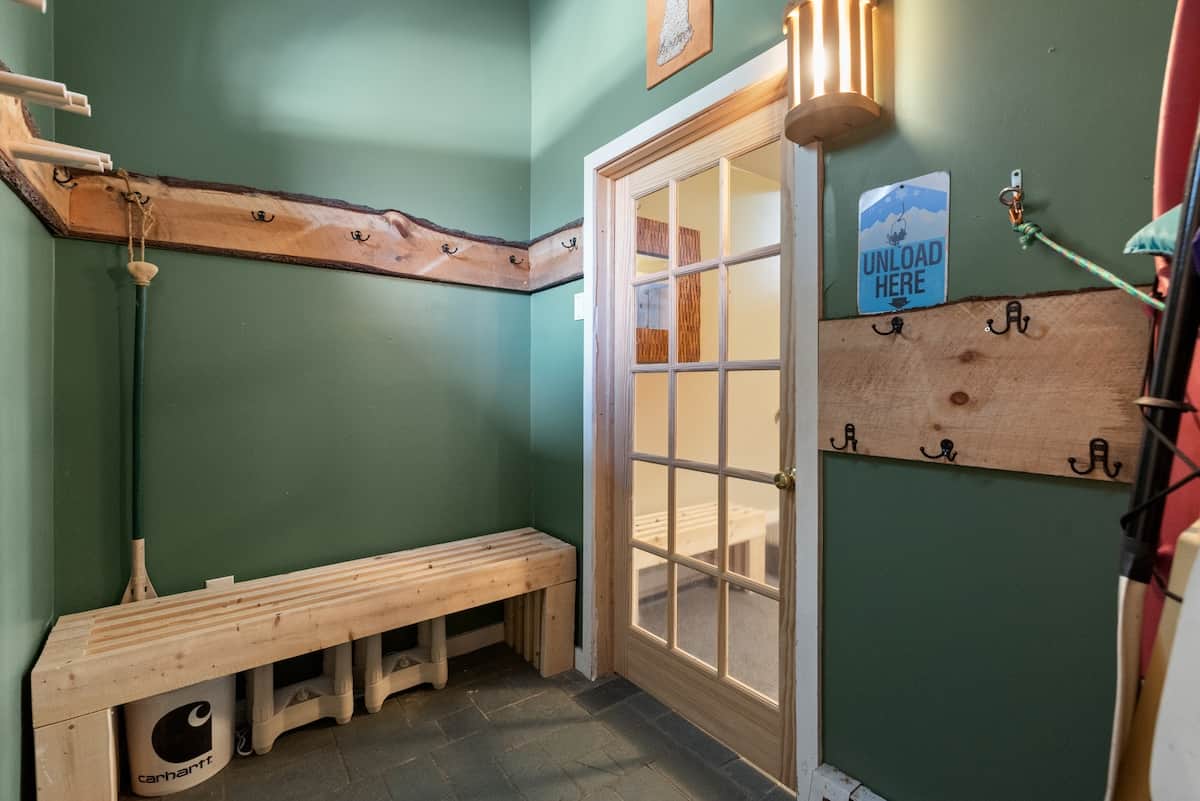 Mudroom with plenty of room, ski racks, and coat hooks to unload and store gear out of the way..