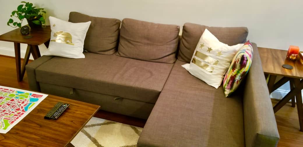 Couch before pulling out the bed . Extra pillows, blankets, etc. are in the sectional storage!