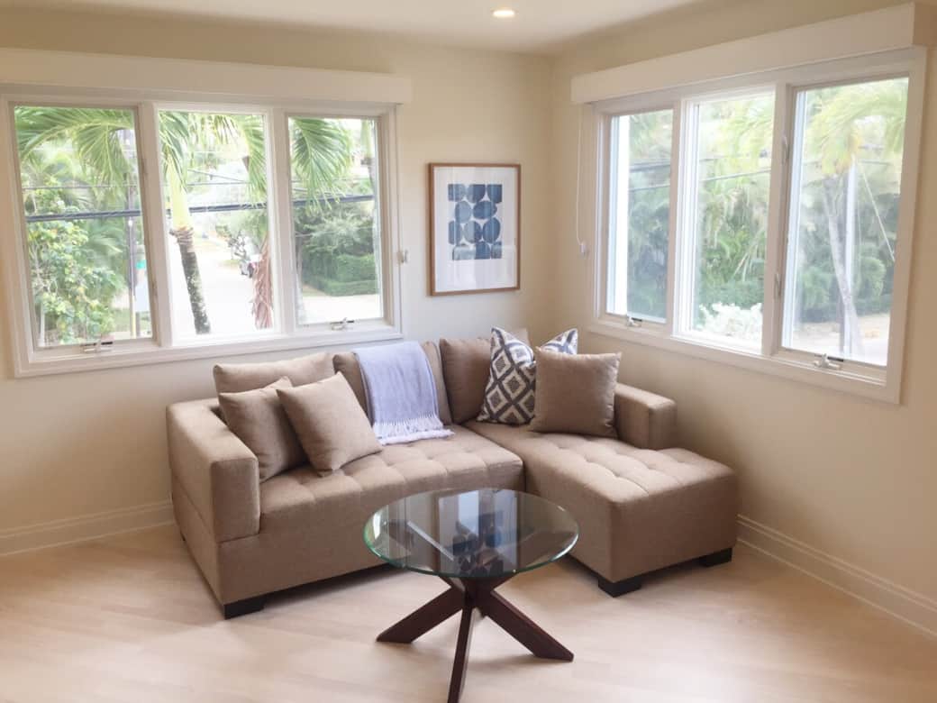 Bright windows over the comfy sofa