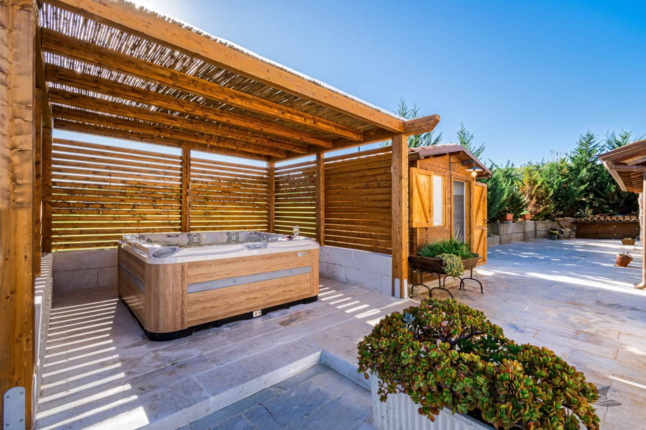 Enjoy the hot tub next to the pool, with an outdoor bathroom conveniently located right beside it.