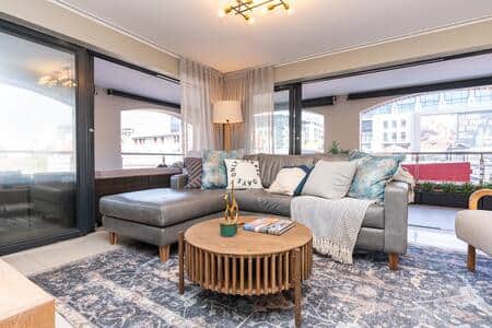 A stylish and spacious living room with modern furnishings and abundant natural light. A stylish and spacious living room with modern furnishings and abundant natural light.