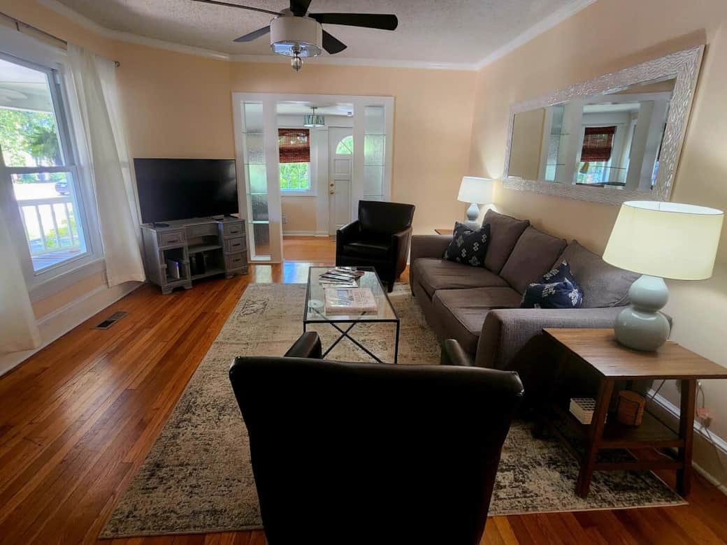 An inviting living space designed for gathering — perfect for relaxing after a wedding celebration, graduation ceremony, or a full day exploring downtown Cary.