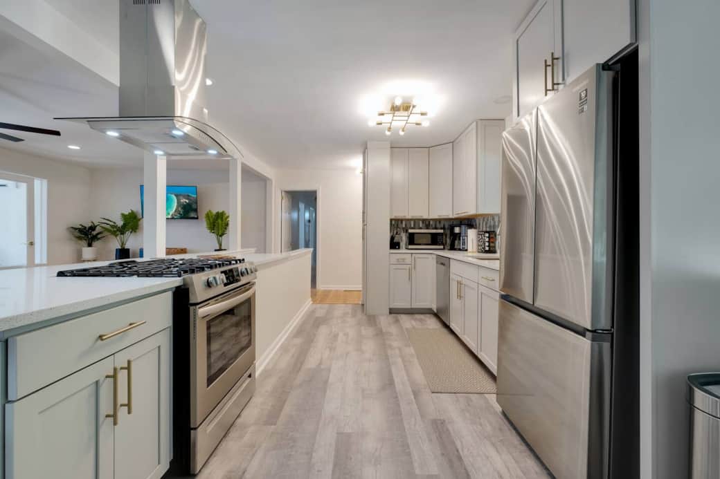 Gas range and island hood vent are gorgeous and functional.