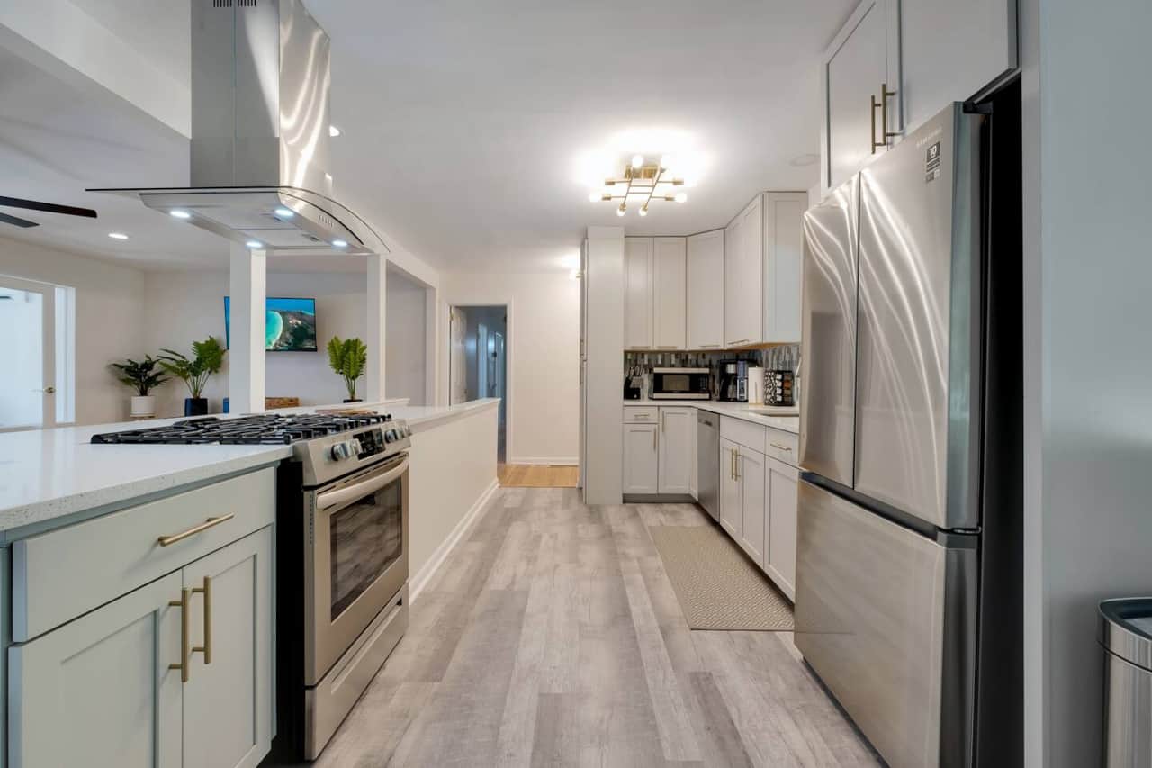 Gas range and island hood vent are gorgeous and functional.