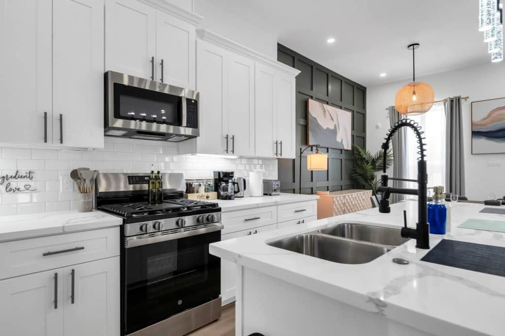 Enjoy cooking with full-size stainless steel appliances, including a gas range, large fridge, microwave, and dishwasher. The kitchen is fully equipped with cookware, utensils, and a full set of dishes. Enjoy cooking with full-size stainless steel appliances, including a gas range, large fridge, microwave, and dishwasher. The kitchen is fully equipped with cookware, utensils, and a full set of dishes.