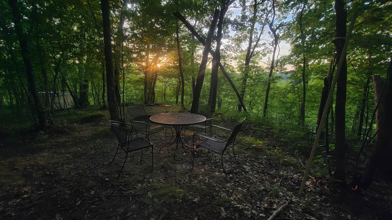 Table at sunset, bed in background