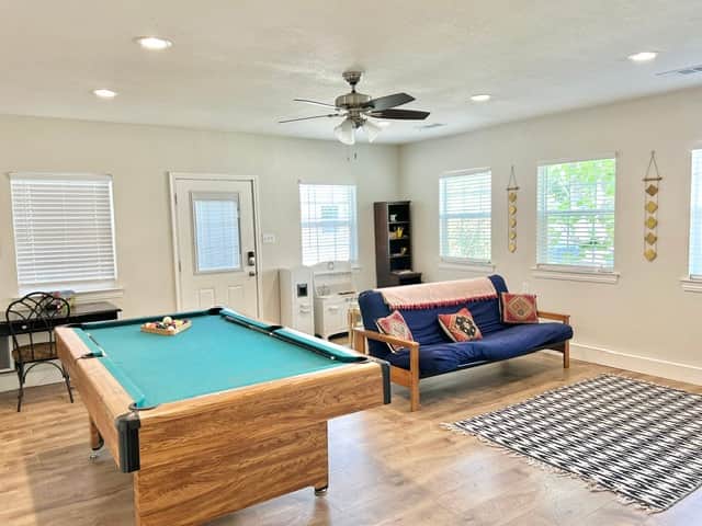 Game room with futon, Xbox, pool table and kids play area