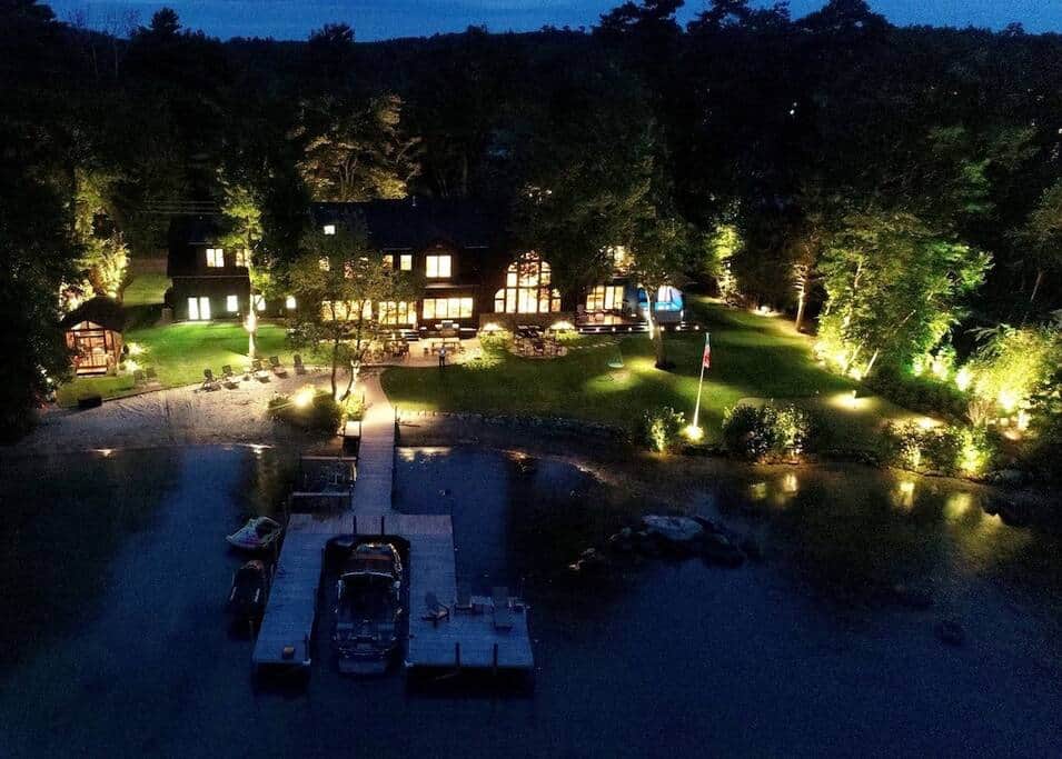 Night view of house with landscape lighting.