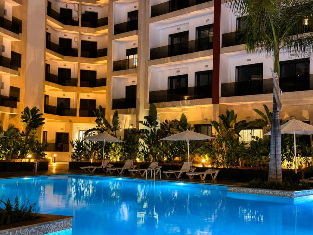 Beautiful outdoor swimming pool surrounded by landscaped gardens and a modern residential complex. A perfect place to relax, sunbathe, and enjoy resort-style living. Beautiful outdoor swimming pool surrounded by landscaped gardens and a modern residential complex. A perfect place to relax, sunbathe, and enjoy resort-style living.