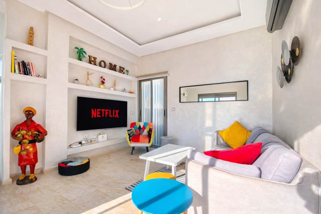 Modern living space with natural light, playful colors, and a welcoming setup—perfect for unwinding, streaming, or spending time together. Modern living space with natural light, playful colors, and a welcoming setup—perfect for unwinding, streaming, or spending time together.