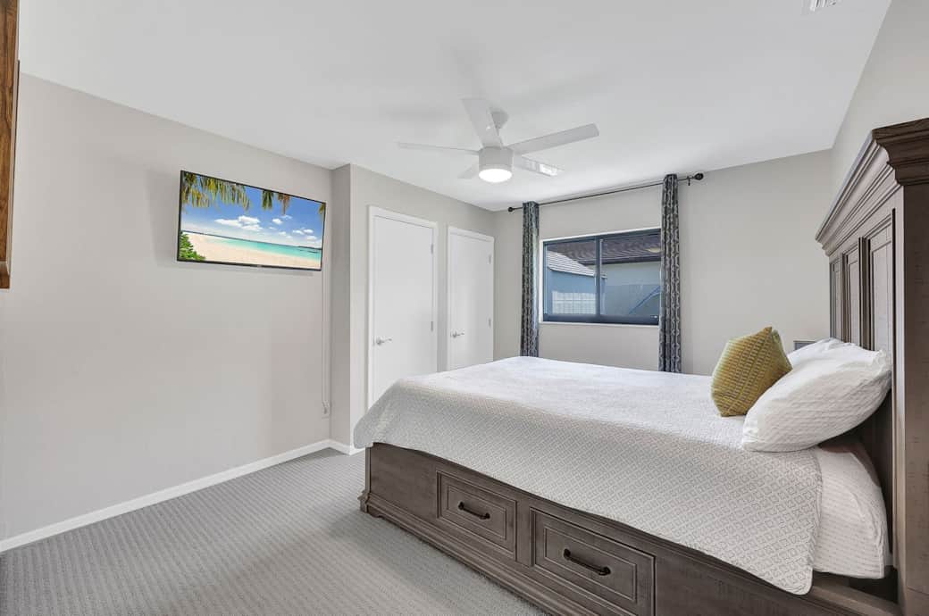 This queen size bedroom is next to the adjacent full bathroom #2 and has a TV. 
