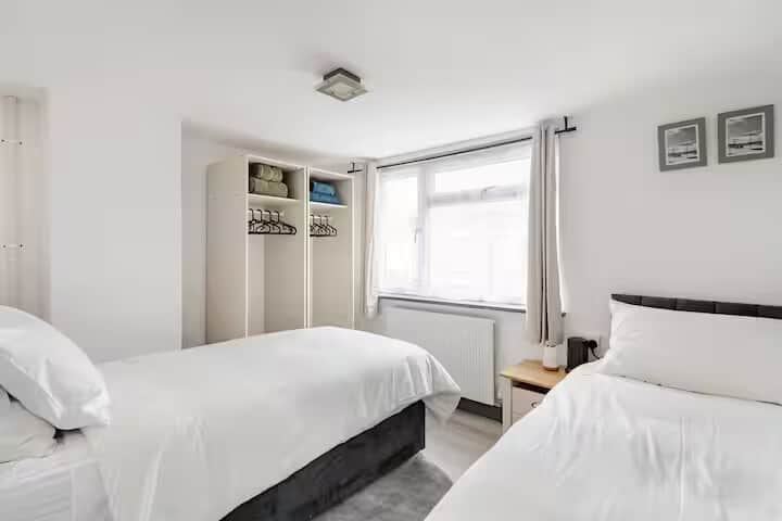 Two twin beds that can be linked into a large double, offering flexible sleeping arrangements.